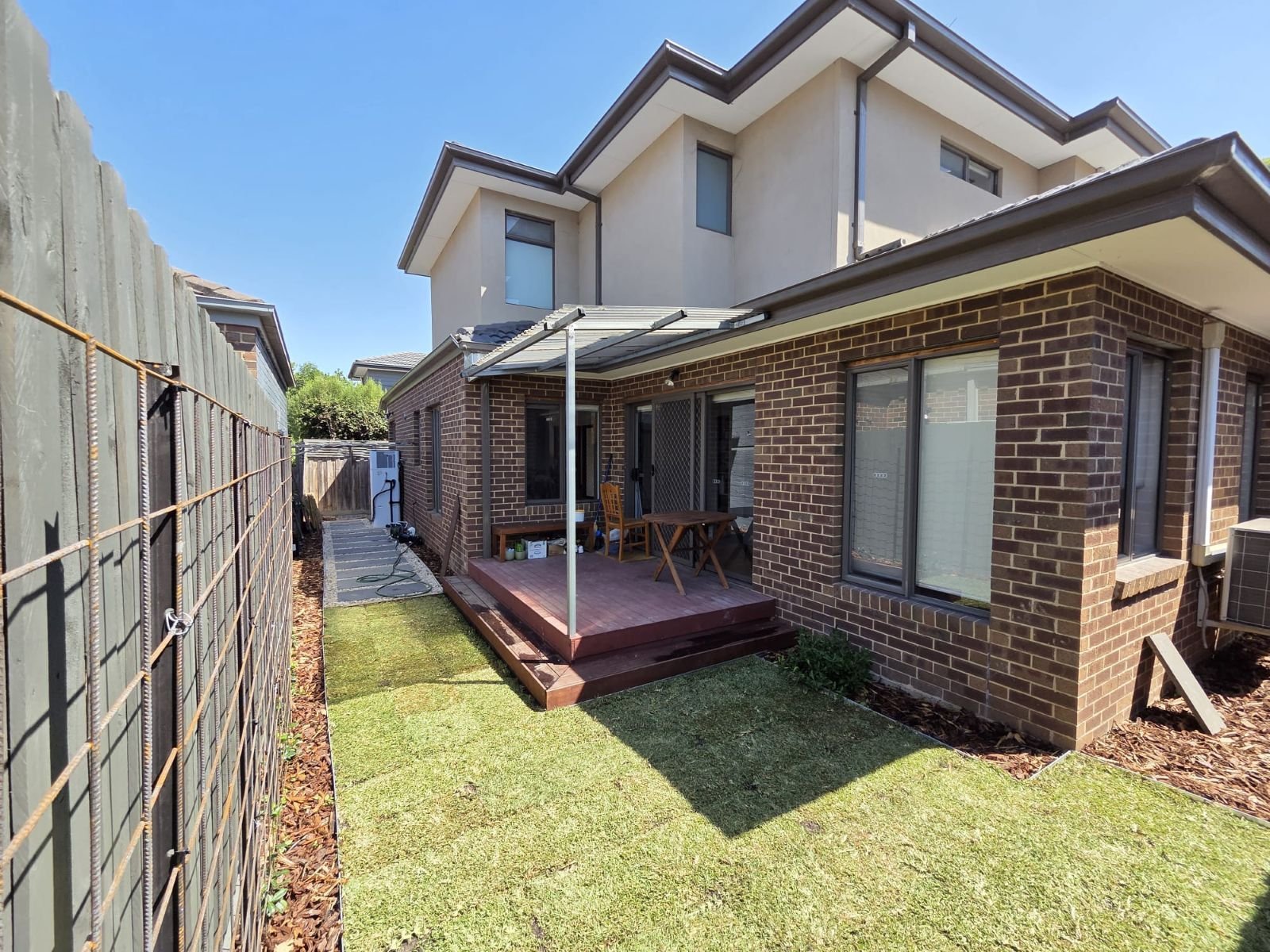Completed backyard with timber deck, new turf and side path at a Melbourne townhouse