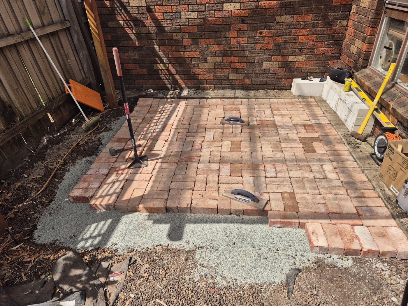 Concrete-bedded soldier course and screeded base ready for brick paving