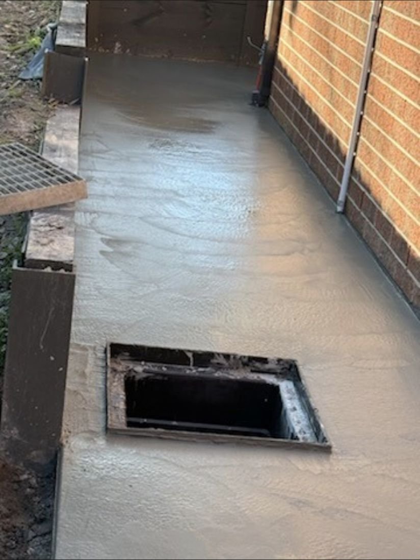 Concrete side path formed around a stormwater pit