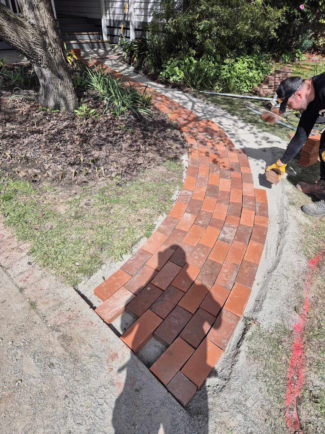 Curved brick path being laid