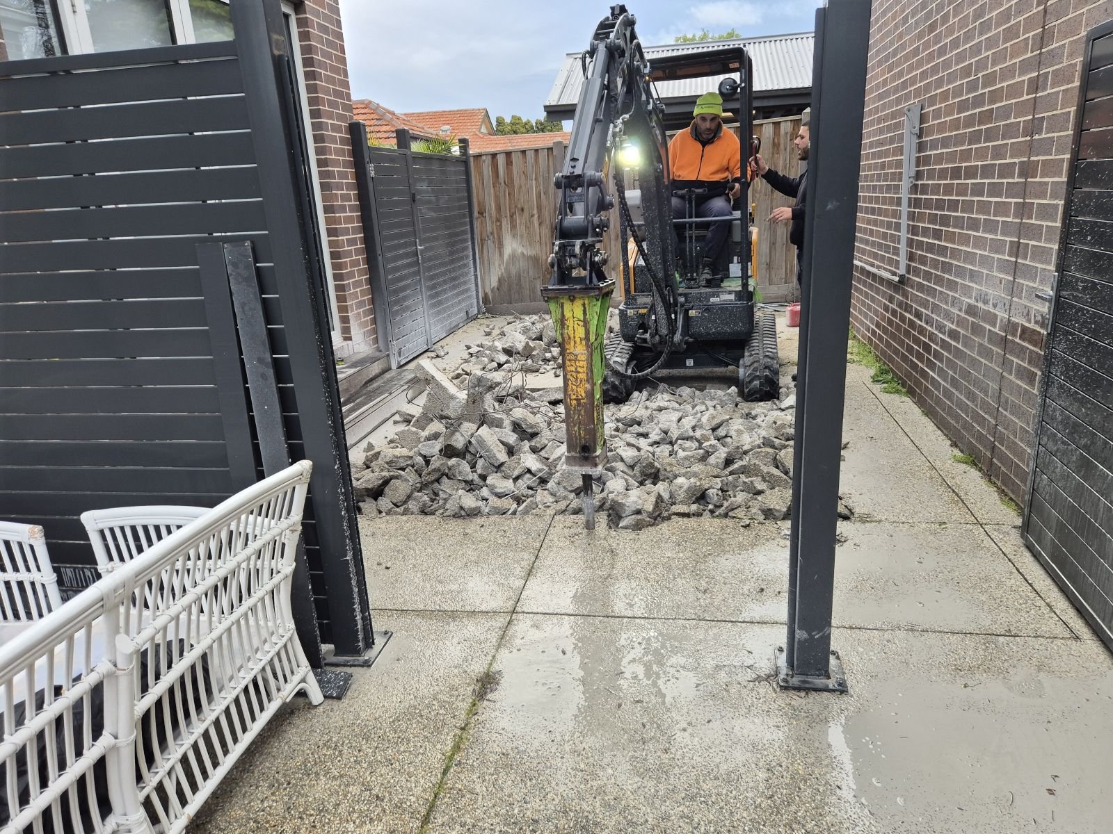 Rock breaker demolishing concrete