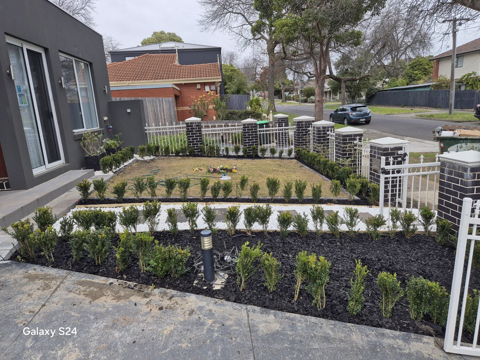 Completed front garden with hedges, turf, pebble path and lighting