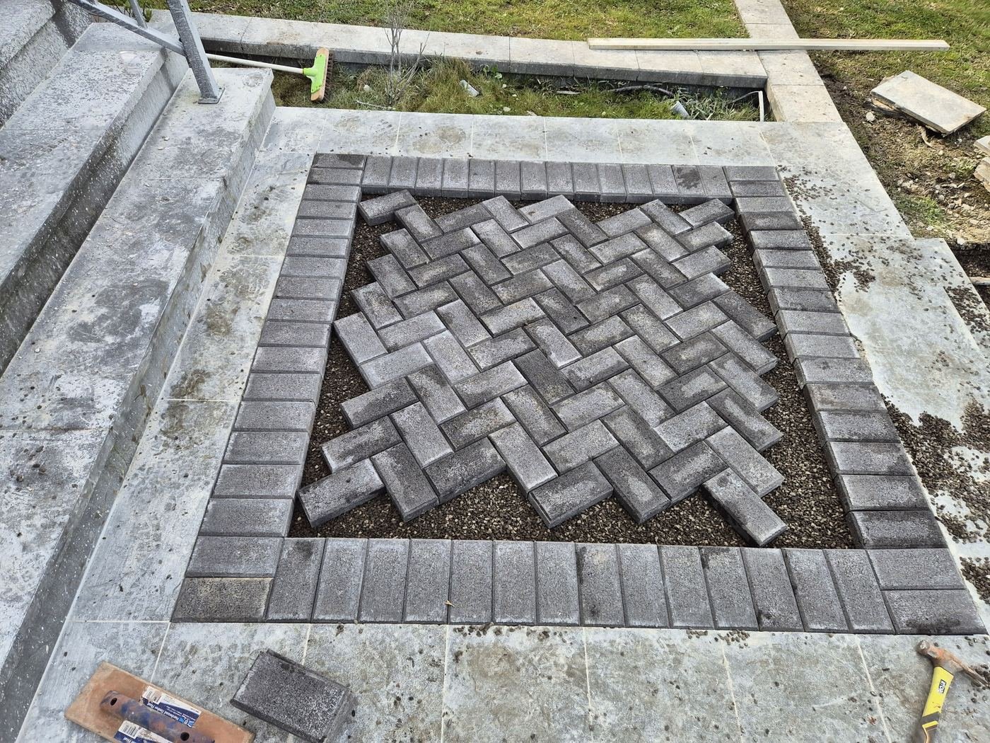 Herringbone paver inlay in concrete