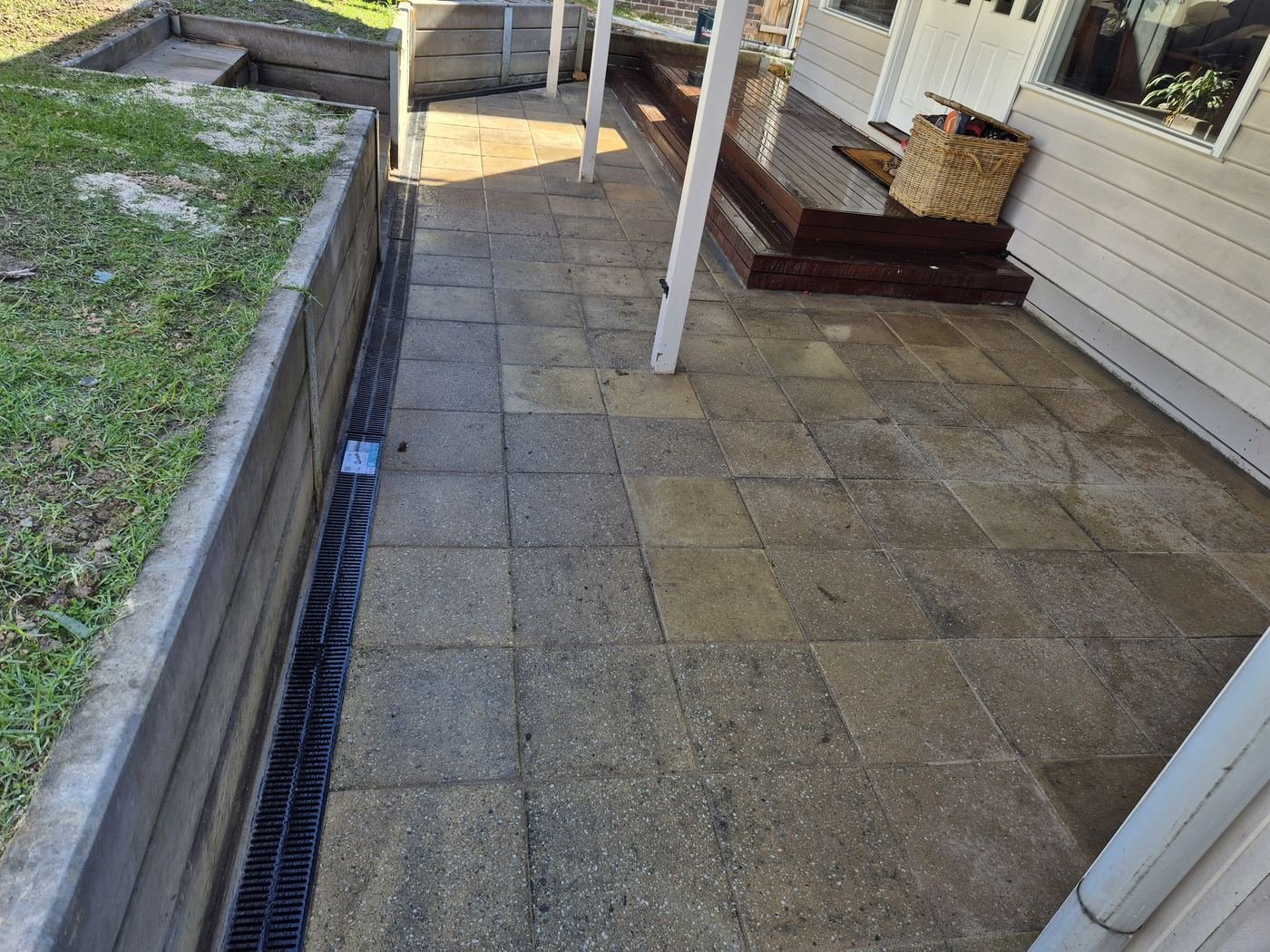 Paving with strip drain beside lawn