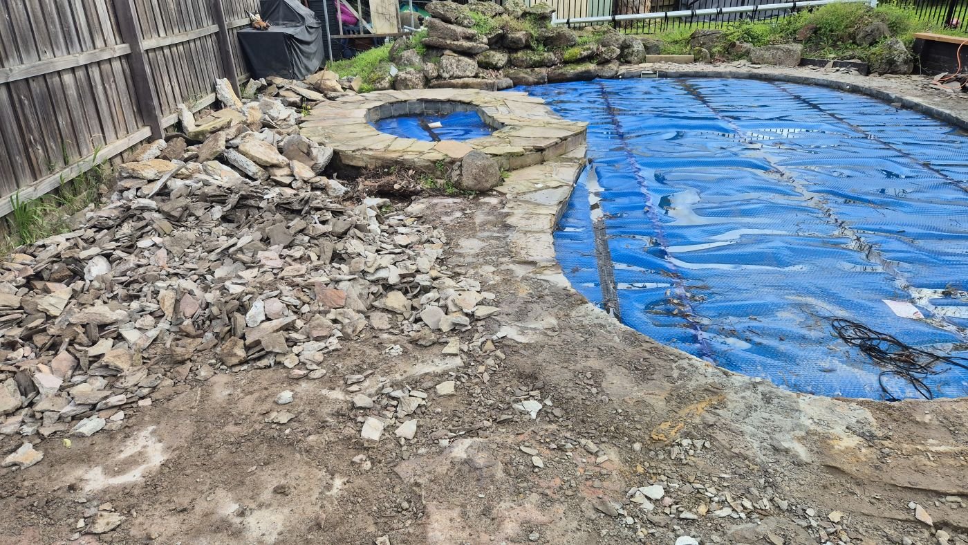 Old flagstone pool paving being removed during demolition
