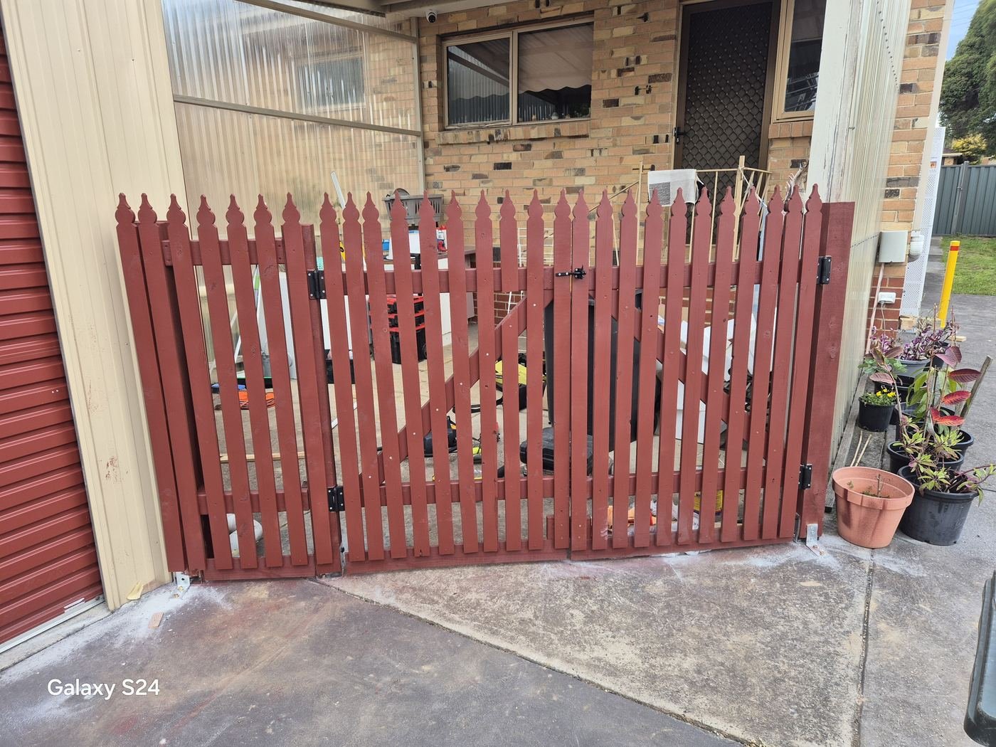 Red timber picket gates