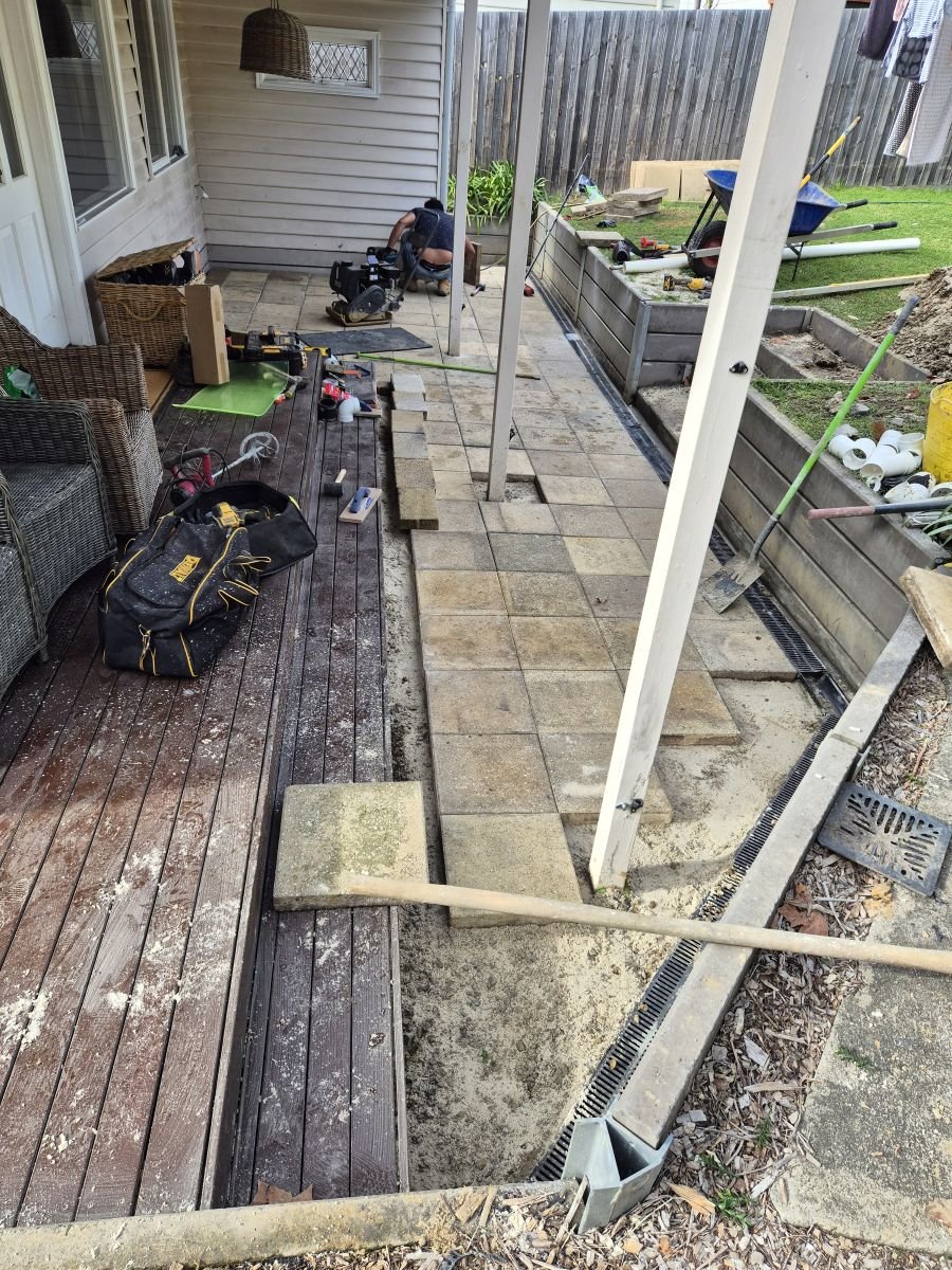 Sandstone path being installed beside a timber deck