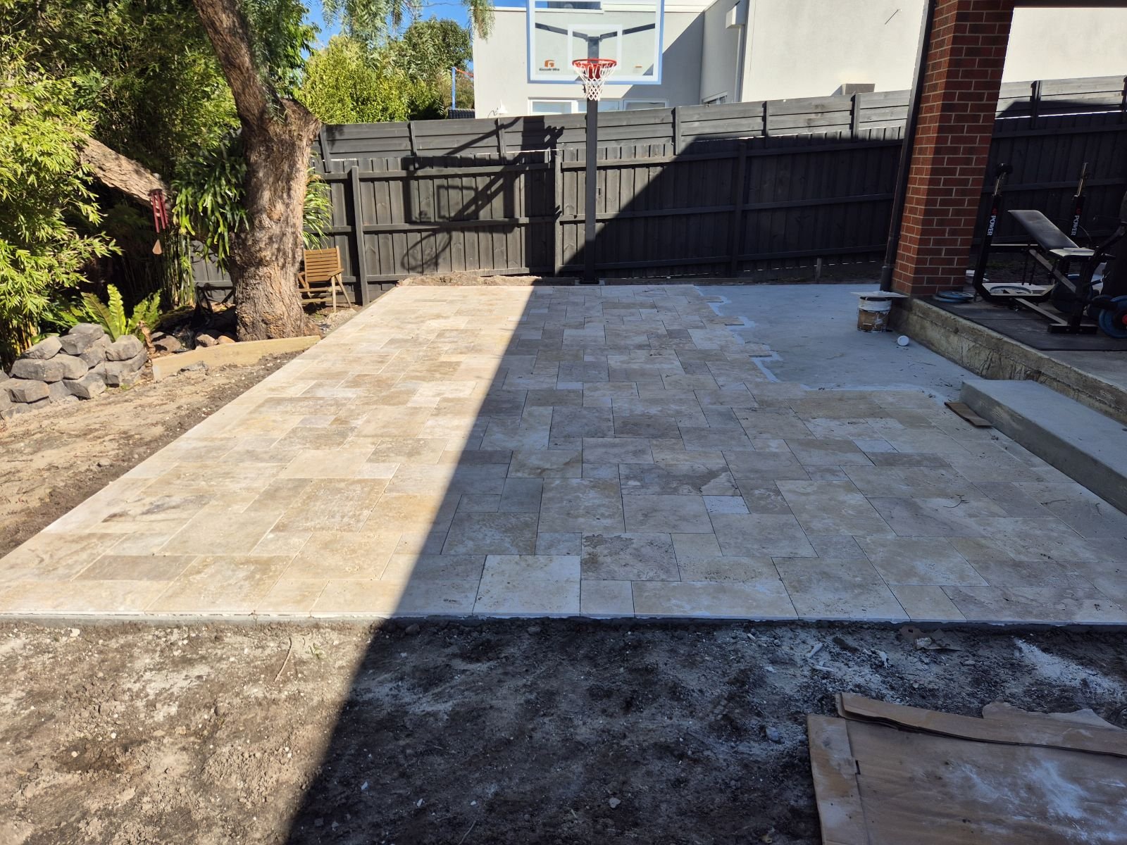 Travertine backyard patio paving in afternoon light