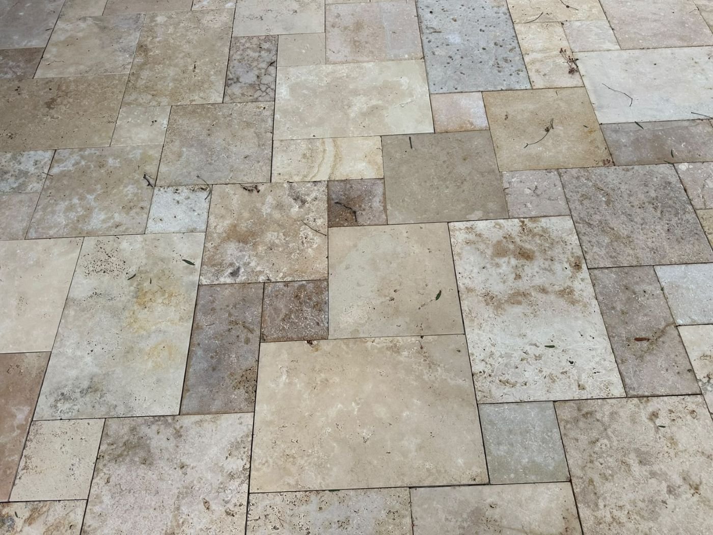 Close-up of travertine pavers in a French pattern