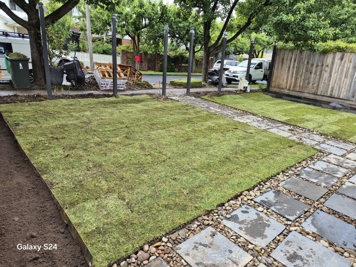 New turf lawn with bluestone stepping stones in pebbles